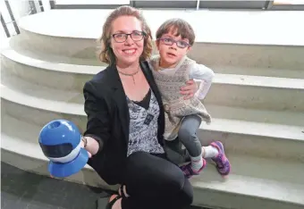  ?? MIKE DE SISTI / MILWAUKEE JOURNAL SENTINEL ?? Christine Carr, who graduates Saturday from Milwaukee Institute of Art & Design, holds her drone prototype, which she was inspired to create by her 6-year-old daughter, Lillian, who has autism.