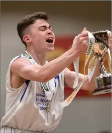  ??  ?? Sligo Grammar captain Mark McGlynn lifts the trophy.