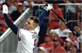  ?? PATRICK SEMANSKY / The Associated Press ?? Atlanta’s Freddie Freeman follows through on his swing during the Home Run Derby on Monday at Nationals Park.