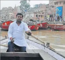  ?? HT PHOTO ?? Vinod Manjhi in his boat at Dashashwam­edh Ghat in Varanasi.