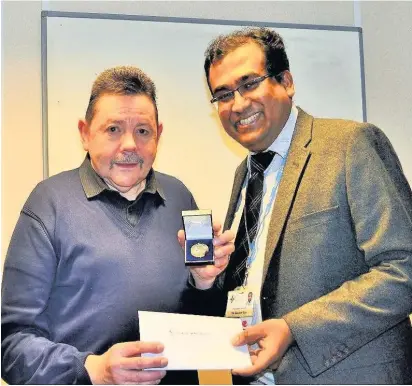  ??  ?? After decades of insulin injections and blood tests, grandfathe­r Allan Jones has been presented with a medal to commemorat­e 50 years with the condition by diabetic consultant Dr Gautam Das from Prince Charles Hospital, Merthyr Tydfil