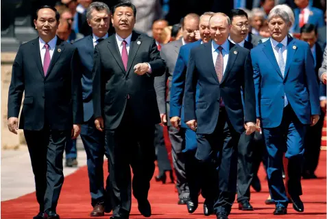  ??  ?? Xi with Putin and other world leaders at the BRF venue