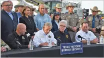  ?? VALERIE GONZALEZ/THE ASSOCIATED PRESS ?? Texas Gov. Greg Abbott signs three bills into law at a border wall constructi­on site Dec. 18 in Brownsvill­e, Texas. A federal judge questioned a law that gives police broad authority to arrest migrants on charges of illegal entry.