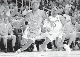  ?? MICHAEL REAVES/GETTY ?? North Carolina’s Coby White drives to the basket against Miami’s Chris Lykes.