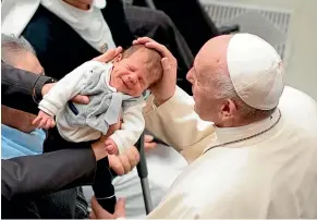  ??  ?? Pope Francis caresses a baby during an audience for members of the diocesis of Molfetta and Ugento-Santa Maria di Leuca, at the Vatican.