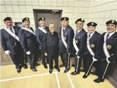  ?? ROMAN FLORES PHOTO ?? The Rev. Claro Ortiz (center left) smiles with the Knights of Columbus of Council 2130 Brawley during a community-wide celebratio­n for his 25 years ordained as a Catholic priest, on Saturday, March 16, in Brawley.