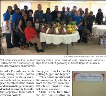  ?? SULAIMAN ABDUR-RAHMAN - THE TRENTONIAN ?? Volunteers, including Bordentown City Police Department officers, prepare approximat­ely 100 meals for a Thanksgivi­ng-style food basket giveaway at Shiloh Baptist Church in Bordentown City on Saturday.