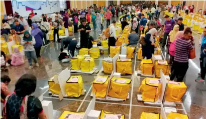  ?? AP ?? Workers from Election Commission get final checks on ballot sets, which are to be sent out in Kuala Lumpur, Malaysia, on Tuesday. —