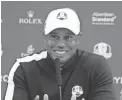  ??  ?? Tiger Woods speaks to the media after a Ryder Cup practice round.