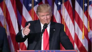  ?? Getty Images ?? Donald Trump gives a thumbs up to the crowd during his acceptance speech at his election night event at the New York Hilton Midtown in the early morning hours of Nov. 9, 2016.