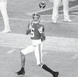  ??  ?? Alabama wide receiver DeVonta Smith catches a touchdown in front of Ohio State cornerback Shaun Wade during the College Football Playoff national championsh­ip game on Jan. 11. Wilfredo Lee