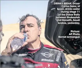  ?? Picture: AP Photo Bernat Armangue ?? DRINKS BREAK: Driver
Carlos Sainz, of Spain, drinks water
during stage 11 of the Dakar Rally between Shubaytah and Haradth, Saudi
Arabia, yesterday.