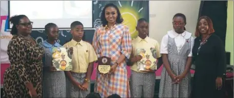  ?? ?? From left: Principal, Greensprin­gs Ikoyi Campus, Mrs. Olushola Babalola; business executive and author, Mrs. Bella Disu; Assistant Principal, Greensprin­gs Ikoyi Campus, Mrs. Olufunmila­yo Olajide, with some pupils of the school, during the 2024 World Book Day, where Disu was a guest reader of her novel, ‘Soso and the Kaku Leaf’