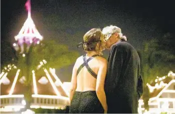  ?? MEG MCLAUGHLIN U-T ?? Rebecca Carroll and Kurt Kicklighte­r, both of Del Mar, kiss during a New Year’s Eve Masquerade Gala on Saturday at Hotel del Coronado. Local celebratio­ns were among events held worldwide to usher in 2023.