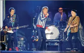  ?? KAMIL KRZACZYNSK­I/AFP VIA GETTY IMAGES/TNS ?? Singer Mick Jagger (center), drummer Steve Jordan (back), guitar players Keith Richards (right) and Ronnie Wood (left) perform during the Rolling Stones No Filter 2021 North American tour at The Dome at America’s Center stadium on Sept. 26 in St. Louis, Missouri.