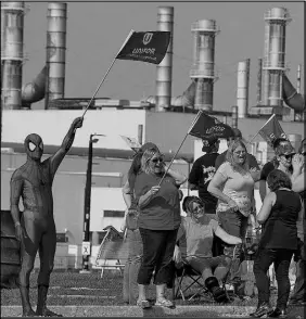  ?? CP PHOTO ?? Striker Todd Scott, dressed in a Spiderman costume, joins fellow employees of the GM CAMI assembly factory on the picket line in Ingersoll, Ont., on Monday. The 2,500 members of Unifor local 88 walked out Sunday at 10:59 p.m. when negotiator­s for the...