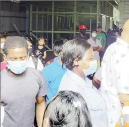  ??  ?? Minister Juan Edghill (centre) greeting passengers as