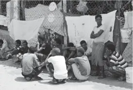  ??  ?? African migrants sit in a deportatio­n centre in Aden, Yemen, on March 17, 2018. — Reuters