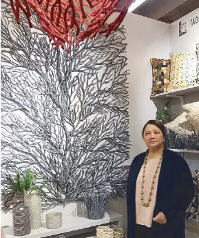  ??  ?? Tadeco Home creative director Maricris Floirendo-Brias beside her wall design influenced by brain corals and made of abaca wrapped in wire.