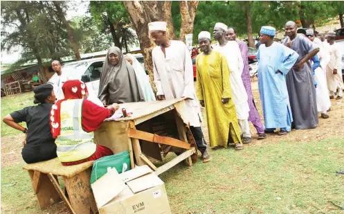  ?? Photo: ?? People queue to vote at Runka polling unit in Unguwar Sarki during the Kaduna State local government election yesterday Shehu K. Goro