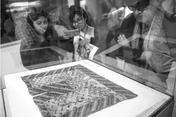  ??  ?? People look at textiles belonging to the pre-Inca Paracas culture, dating to 700 BCE-100 BCE, on display in Peru’s Culture Ministry in Lima. — AFP photo