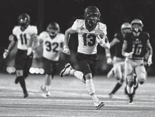  ?? Jason Fochtman / Staff photograph­er ?? Fulshear wide receiver Jax Medica runs for a 52-yard touchdown during the first quarter against Lake Creek. Medica also had a 13-yard TD reception and finished with five catches for 102 yards.