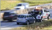  ?? BEN HASTY — MEDIANEWS GROUP ?? A tow truck and car are set up as a part of an awareness campaign on Route 422in Exeter Township on Tuesday for drivers to change lanes lanes when passing a tow truck or emergency services vehicle on the side of the road.