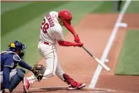  ?? AP Photo/Jeff Roberson ?? ■ St. Louis Cardinals’ Nolan Arenado doubles down the line during the first inning against the Milwaukee Brewers on April 10 in St. Louis. Los Angeles Dodgers pitcher Trevor Bauer is the highest-paid player in 2021 at $38 million after agreeing to a $102 million, three-year contract he can terminate after one season. Los Angeles Angels outfielder Mike Trout is second at $37.1 million, followed by Yankees pitcher Gerrit Cole ($36 million) and St. Louis third baseman Arenado ($35 million), who was acquired in a trade with Colorado.