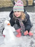  ??  ?? • Rose Tudor, aged 5, with her snow penguin