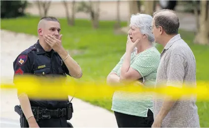  ?? BRET T COOMER /The ASSOCIATED PRESS ?? People talk with a law enforcemen­t officer near the scene of a shooting Wednesday in Spring, Texas. Two adults and three children were discovered dead at the scene, and a fourth child died later in hospital.