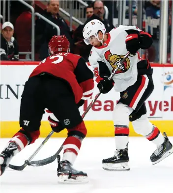  ?? RICK SCUTERI/THE ASSOCIATED PRESS ?? Ottawa centre Colin White shoots in front of Arizona Coyotes defenceman Jordan Oesterle during their game Tuesday in Glendale, Ariz. For game results go to ottawaciti­zen.com.