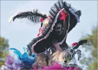  ?? VICTOR CRUZ / AFP ?? A person takes part in the Day of the Dead parade in Mexico City on Saturday.