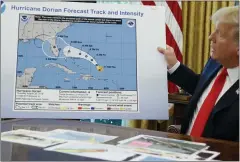  ?? EVAN VUCCI — THE ASSOCIATED PRESS ?? President Donald Trump holds a doctored map as he talks with reporters after receiving a briefing on Hurricane Dorian in the Oval Office on Wednesday.