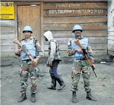  ?? THE ASSOCIATED PRESS FILES ?? Two UN soldiers stand guard in Goma, Democratic Republic of Congo.
Rebels attacked a UN peacekeepi­ng base in eastern Congo, killing at least 14 peacekeepe­rs and wounding 53 others on Friday.