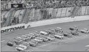  ?? [AP PHOTO] ?? Alex Bowman, front left, and Chase Elliott lead the field to start the NASCAR Cup Series auto race at Daytona Internatio­nal Speedway, on Saturday in Daytona Beach, Fla.