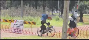  ?? NEWS/KEN SMITH. PHOTO: DUBBO PHOTO ?? These naughty cyclists need to spend some more time brushing up on their reading, as the sign clearly says the track is closed.