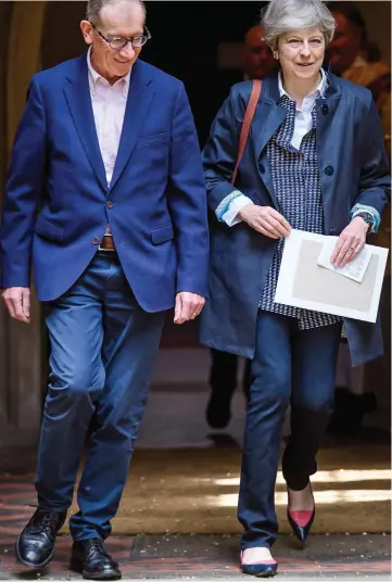  ??  ?? Campaign break: Theresa May at church with her husband Philip yesterday