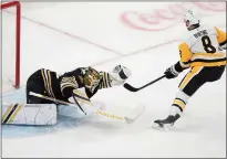  ?? MICHAEL DWYER — THE ASSOCIATED PRESS ?? Boston Bruins’ Linus Ullmark (35) makes a glove save on the shot by Pittsburgh Penguins’ Michael Bunting (8) on a breakaway during the first period of an NHL hockey game, Saturday, March 9, 2024, in Boston.