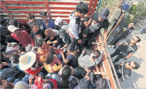  ?? PATIPAT JANTHONG ?? Illegal migrant workers from Cambodia are rounded up at a warehouse in Bangkok in March this year.