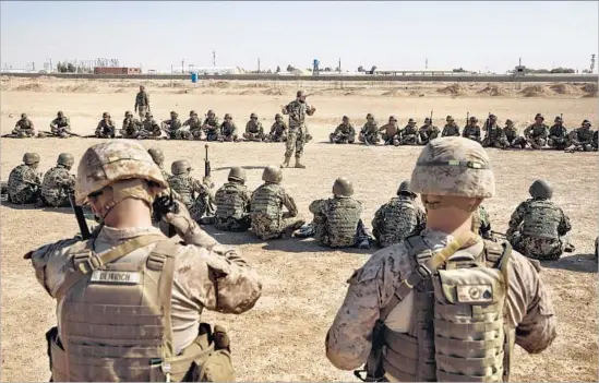  ?? Photograph­s by Marcus Yam Los Angeles Times ?? MARINES Sgt. Matt Deitrich, left, and Sgt. Joseph O’Brien view training at Camp Shorab. About 300 Marines are deployed in Helmand province in advisory roles.