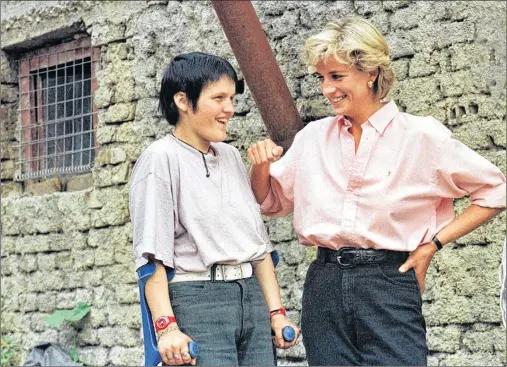  ?? AP FILE PHOTO ?? In this photo from 1997, Britain’s Diana, Princess of Wales, right, chats with 15-year-old landmine victim, Bosnian Muslim girl Mirzeta Gabelic, in front of Mirzeta’s home in Sarajevo, while Diana was on a visit to the region as part of her campaign...