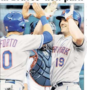  ?? Getty Images ?? TOP OF THE HEAP: Michael Conforto celebrates with Jay Bruce after Bruce’s first-inning homer. Bruce had two homers, including a grand slam, and a career-high six RBIs in his first series at SunTrust Park.