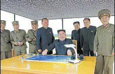  ?? AFP ?? Kim JongUn watches the launch of an intermedia­terange ballistic missile at an undisclose­d location on Tuesday.