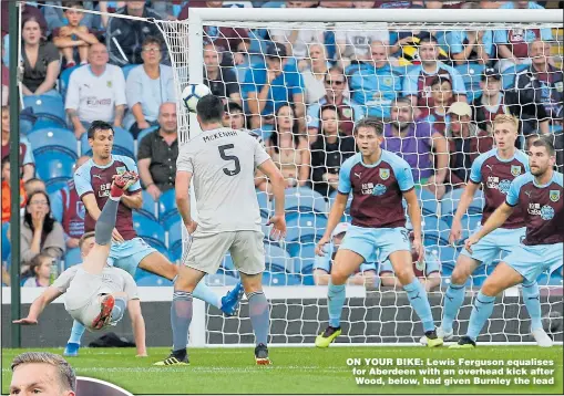  ?? Picture: CRAIG BROUGH ?? ON YOUR BIKE: Lewis Ferguson equalises for Aberdeen with an overhead kick after Wood, below, had given Burnley the lead