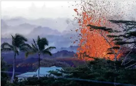  ?? MARIO TAMA / GETTY IMAGES ?? Lava erupts from a Kilauea volcano fissure near a home at dawn Friday on Hawaii’s Big Island in Kapoho, Hawaii. Police, firefighte­rs and the National Guard were securing the area to stop people from entering, Hawaii County Civil Defense reported.