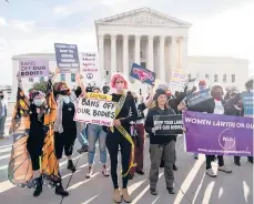 ?? DREW ANGERER/GETTY ?? Abortion rights and anti-abortion activists demonstrat­e Nov. 1 outside the Supreme Court as the justices hear arguments in a challenge to an abortion law.
