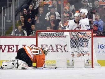 ?? DERIK HAMILTON —– THE ASSOCIATED PRESS ?? The Islanders’ Brock Nelson, right, and Josh Bailey celebrate taking frequently injured goalie Michal Neuvirth to the proverbial woodshed Saturday, amid a 6-1 Flyers humiliatio­n in Neuvirth’s first start of the season.