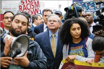  ?? EDUARDO MUNOZ ALVAREZ / GETTY IMAGES ?? U.S. Sen. Robert Menendez (center), D-N.J., joins activists in Newark, N.J., on Wednesday protesting the White House decision to end the Deferred Action for Childhood Arrivals program. Menendez was indicted in 2015 on multiple fraud and bribery...