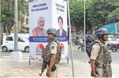  ??  ?? AHMEDABAD: Indian security personnel stand guard alongside a banner advertisin­g the forthcomin­g visit to the city by Japanese Prime Minister Shinzo Abe (right) and Indian Prime Minister Narendra Modi on the eve of the visit in Ahmedabad yesterday. — AFP