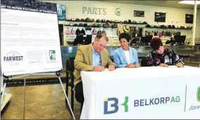  ?? PHOTO BY DAVE KRANZ ?? California Farm Bureau Federation President Jamie Johansson, left, and Far West Equipment Dealers Associatio­n President and CEO Joani Woelfel, right, sign a “right to repair” agreement as Assembly Member Susan Talamantes Eggman, Dstockton, watches. The memorandum of understand­ing says equipment dealers agree to provide manuals, service guides and other informatio­n needed to help farmers diagnose and fix machinery.